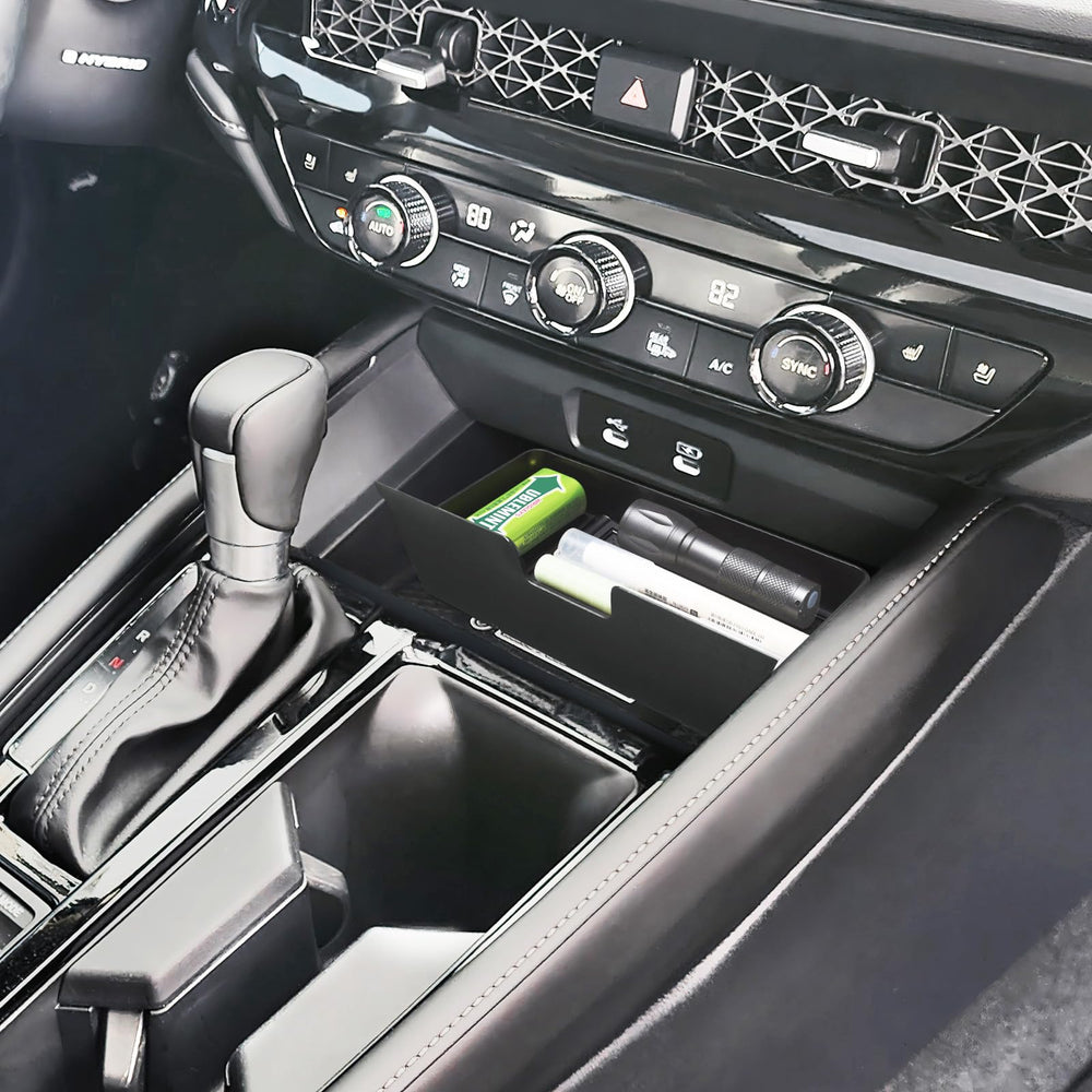 PIMCAR compact storage solution organizes coins and cables in the console.
