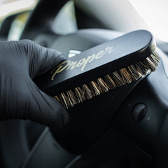 PROPER DETAILING CO. car seat brush in action cleans seams effectively