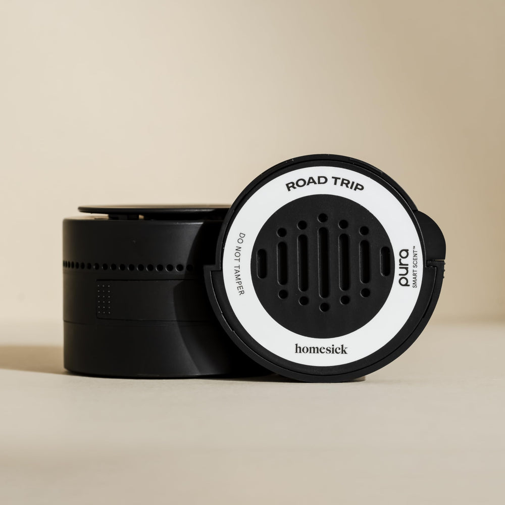 Pura Homesick car diffuser mounted on dashboard for hands-free fragrance.