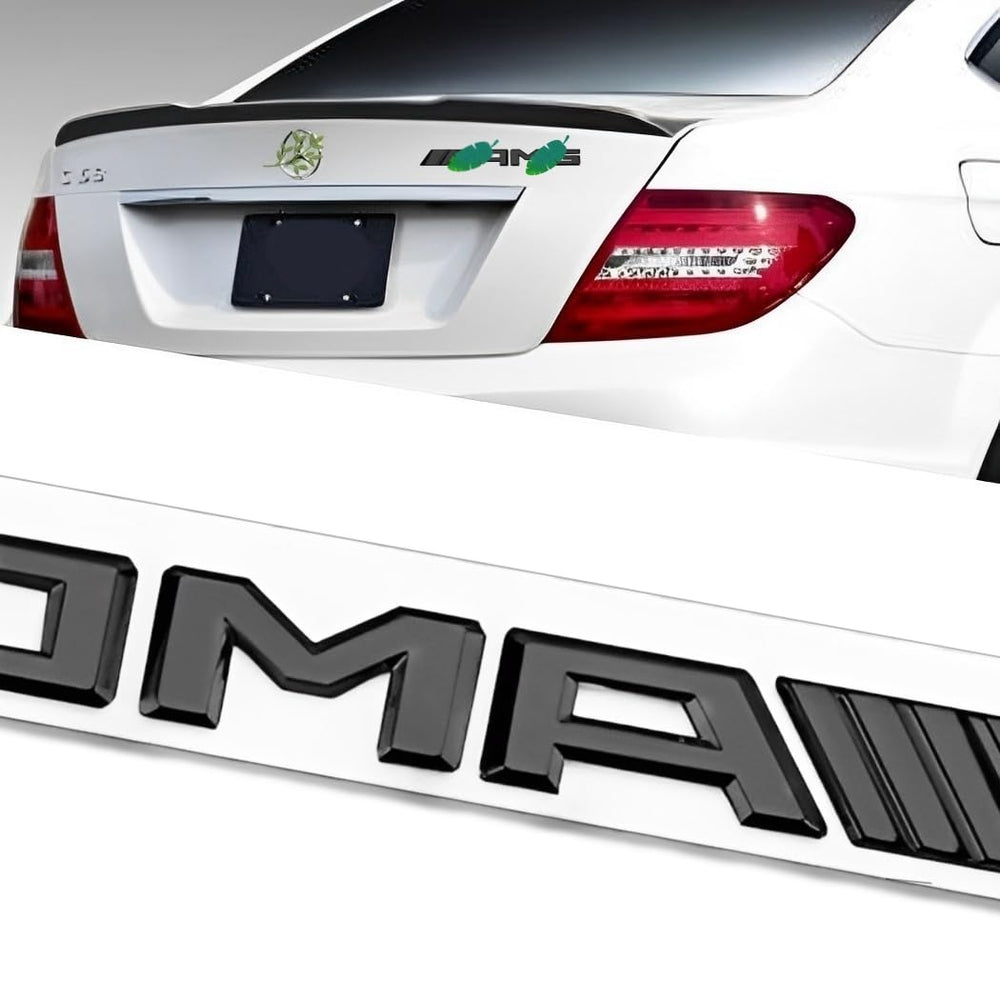 QOMAGO AMG black trunk emblem badge for durable, weather-resistant car customization.