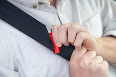 RESQME seatbelt cutter close-up with razor-sharp blade ready