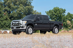 Bolt-on installation sequence for Rough Country 2in leveling kit in a home garage