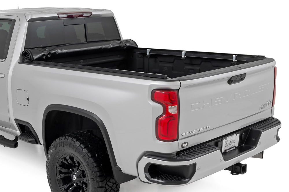 Rough Country soft roll-up bed cover on the GMC Sierra 6-9 bed provides weather protection for cargo.