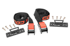 Rough Country cooler tie-down installed in UTV bed with straps stretched.