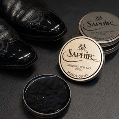 SAPHIR Medaille d’Or bag being polished for renewed luster.