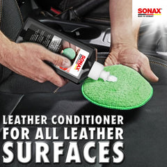 SONAX Leather Care Cream is applied with microfiber cloth on car seat.