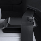 Spigen backseat belt guide holder installed in a Tesla Model Y for neat belt management.