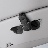 Spigen magnetic vegan leather sunglasses holder for car sun visor provides secure quick access.