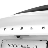 Spigen rear emblem full-cover sticker on Tesla Model 3 Highland provides scratch protection.