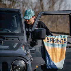 Sprints athletic running towel sasquatch edition branding on trail gear.
