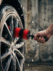 TAKAVU brush in use on a car wheel for detailing.
