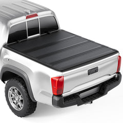 Tono King hard low-profile quad-fold cover on a 60-inch Tacoma bed showing sleek protection