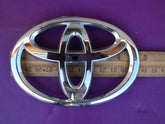 Toyota back-door emblem close-up, official OEM part with easy self-adhesive installation.
