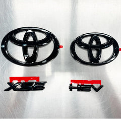 Toyota PT948-03256-02 gloss black emblem overlay on the front badge, adds bold modern style.