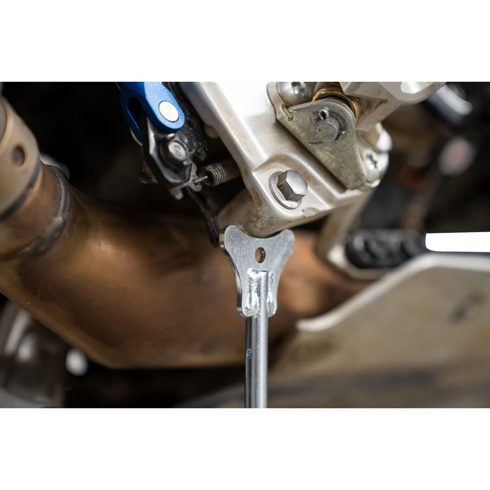 Tusk MotoCrutch positioned for wheel removal and chain adjustments