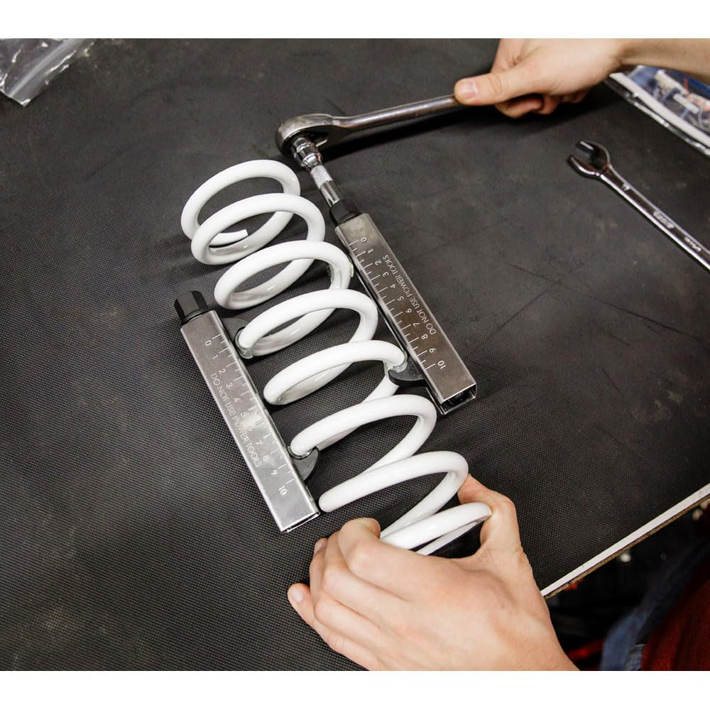 Tusk pair shown on motorcycle shocks ensures balanced, safe installation