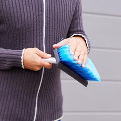 Soft-brush cleaning patio furniture with squeegee for gentle care