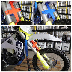 Brace securing a bike on a trailer prevents bounce during transit.
