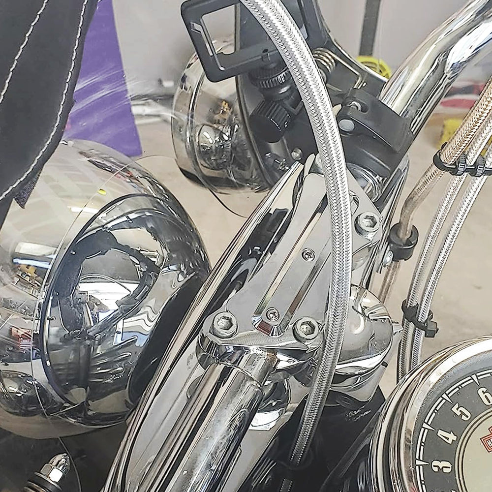 Chrome top clamp close-up showing durable CNC aluminum construction for Harley touring bikes.