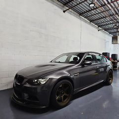 Close-up of high-gloss charcoal grey car surface finished with VViViD wrap.