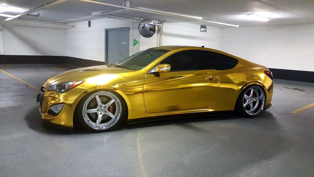 VViViD Gold Mirror Chrome vinyl being applied with bubble-free air release for a smooth finish.