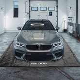 Welkin Containment Mat front view showing full 7'9" x 18' coverage for cars and SUVs