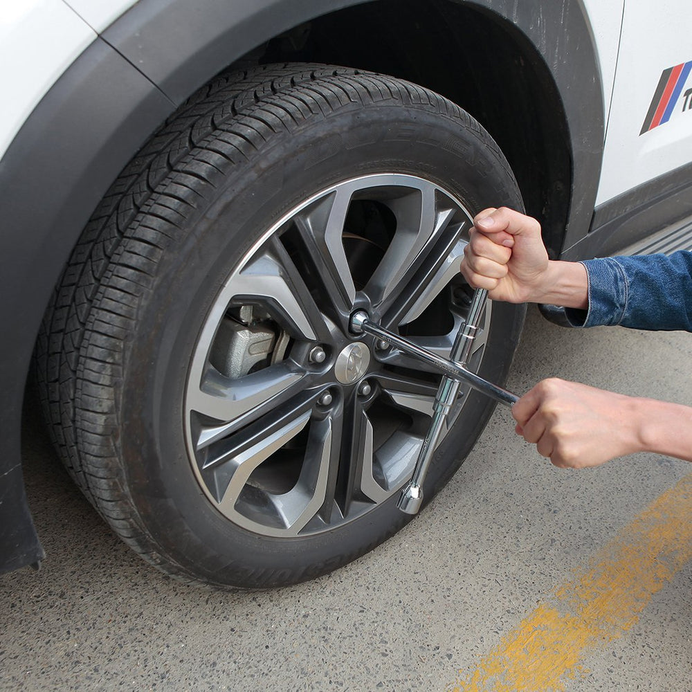 WorkPro folding lug wrench stored neatly in a vehicle emergency kit.