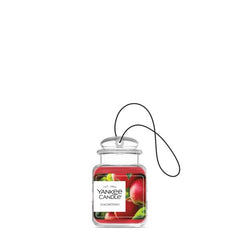 Yankee Candle Car Jar Ultimate Macintosh hanging in a car for easy attachment during drives.