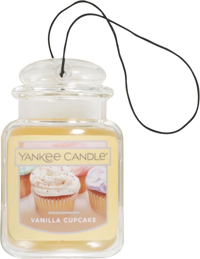 Yankee Candle Car Jar Ultimate Vanilla Cupcake hanging in car boosts aroma