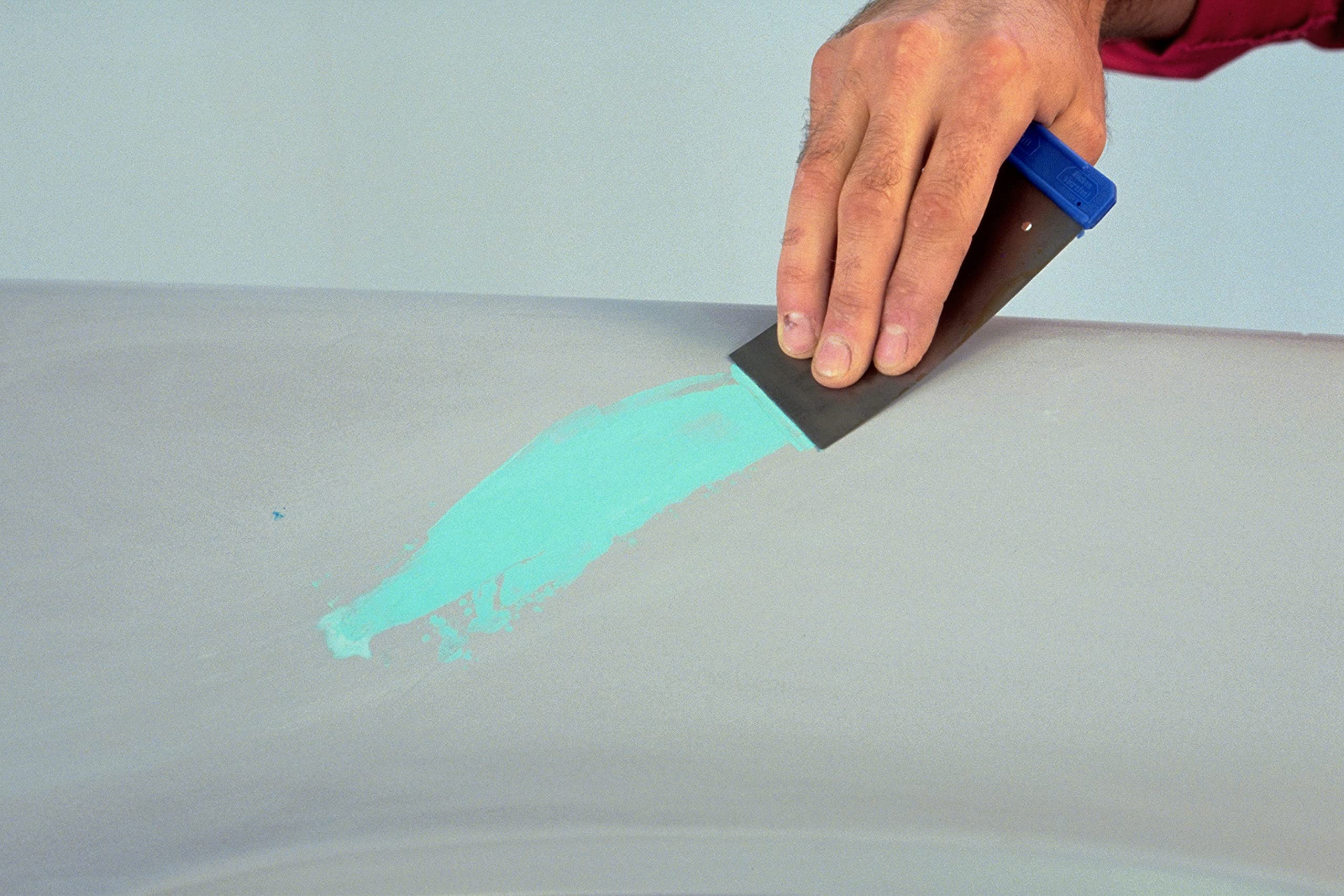 3M Acryl-Green putty being spread for smooth feathering in repairs.