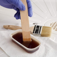 3M Bondo resin and hardener mixing for a strong bond.