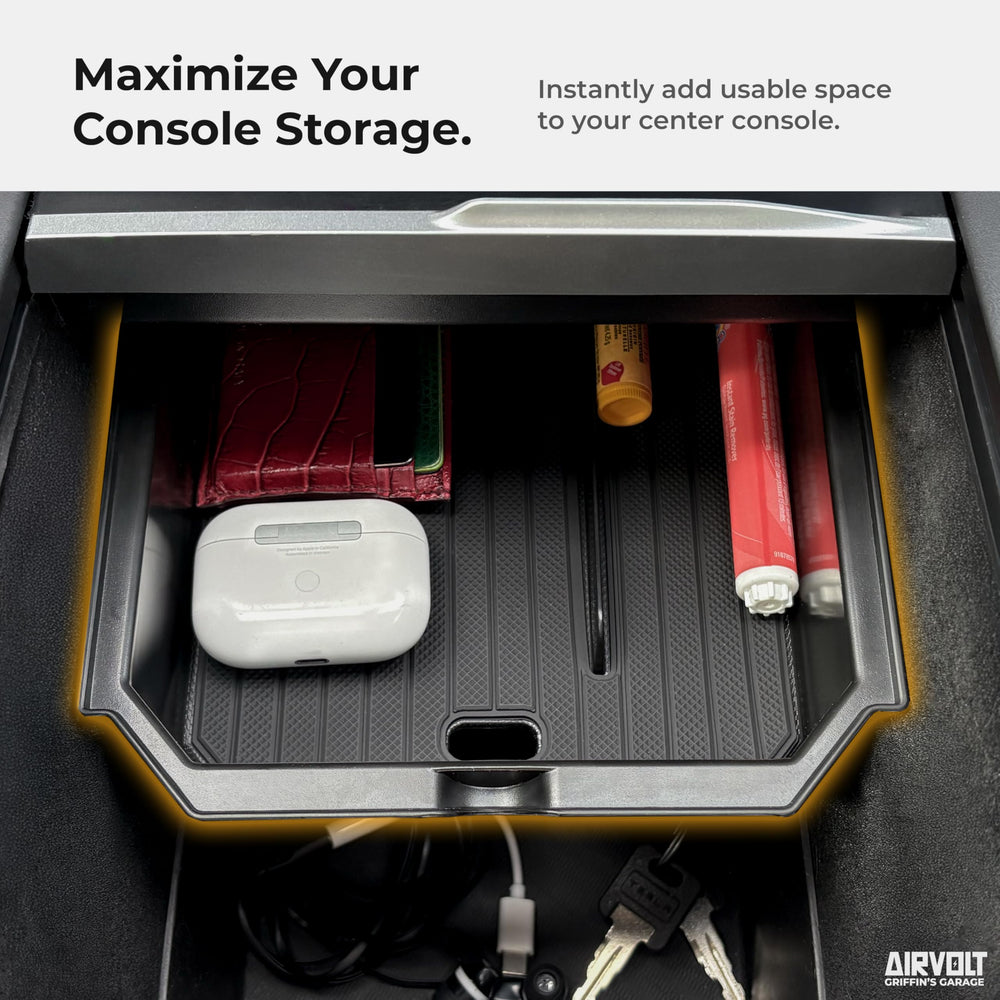 AirVOLT hidden armrest compartment provides discreet storage in Model Y.