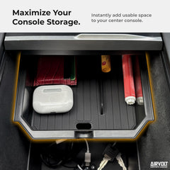 AirVOLT hidden armrest compartment provides discreet storage in Model Y.