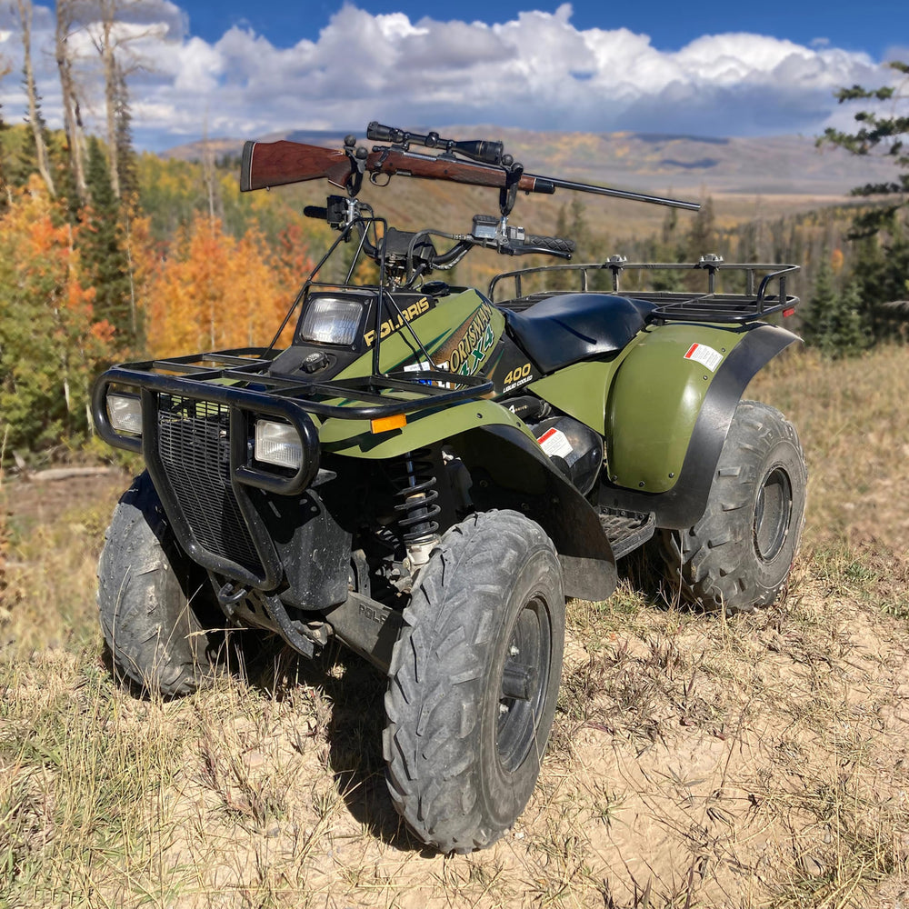 All Rite Pack Rack mounted on ATV handles holds bow securely for quick access.