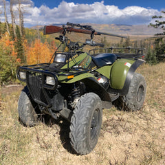 All Rite Pack Rack mounted on ATV handles holds bow securely for quick access.