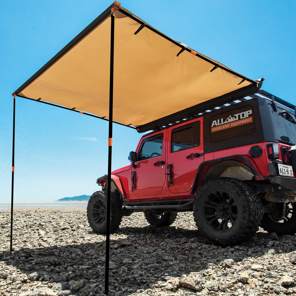 ALL-TOP Vehicle Awning extended beside SUV providing shaded shelter at a campsite.