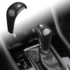 ANFOKAS gear shift knob cover in carbon fiber style enhances cockpit aesthetics and protects the knob.