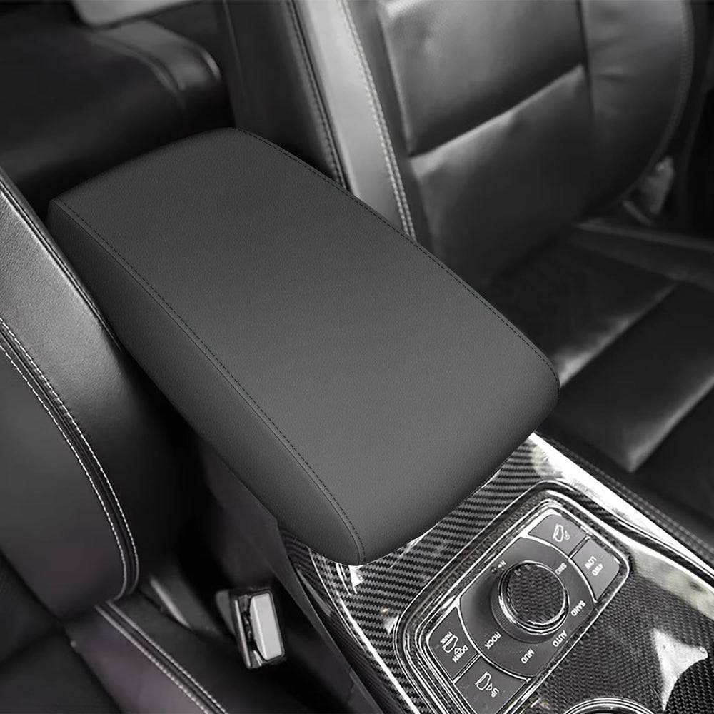 AOMSAZTO black leather armrest cover for Grand Cherokee 2011-2021 protects the console surface.