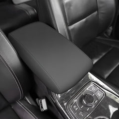 AOMSAZTO black leather armrest cover for Grand Cherokee 2011-2021 protects the console surface.