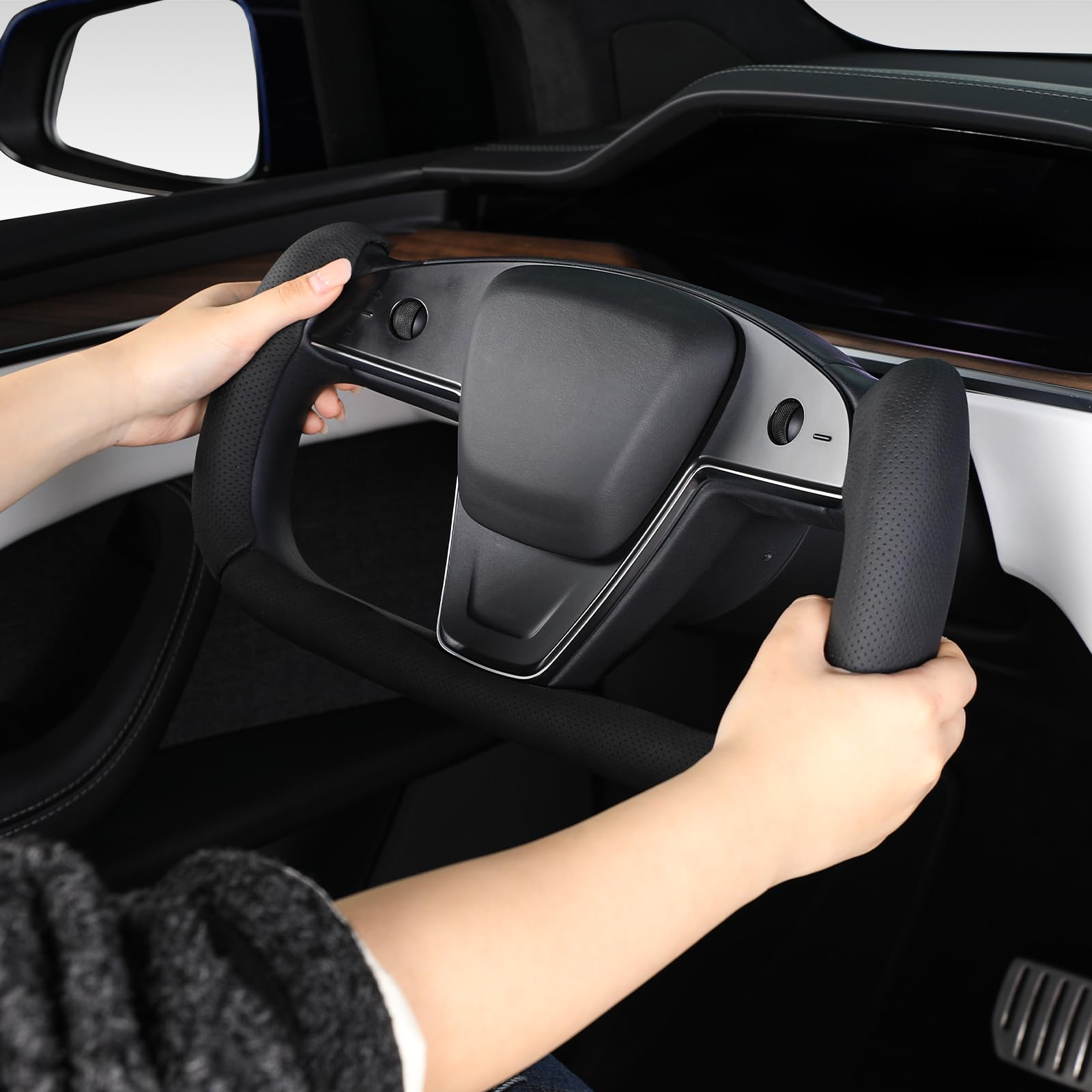 Black Aotoyou steering wheel cover augmenting Tesla interior with premium look.