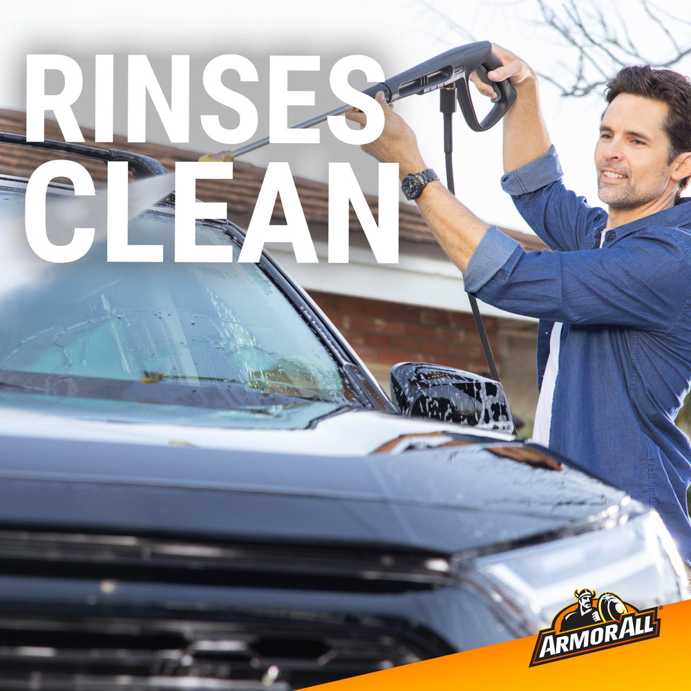 Suds cover a vehicle panel during a thorough wash.