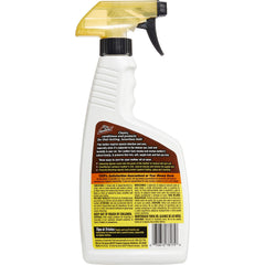Applying Armor All Leather Care Spray on leather seat for cleaning and conditioning