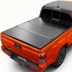 Aurorasters hard tri-fold tonneau cover on Toyota Tacoma side view protecting cargo