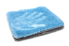 Thick microfiber pad lifting dirt and rinsing in clean water during a wash