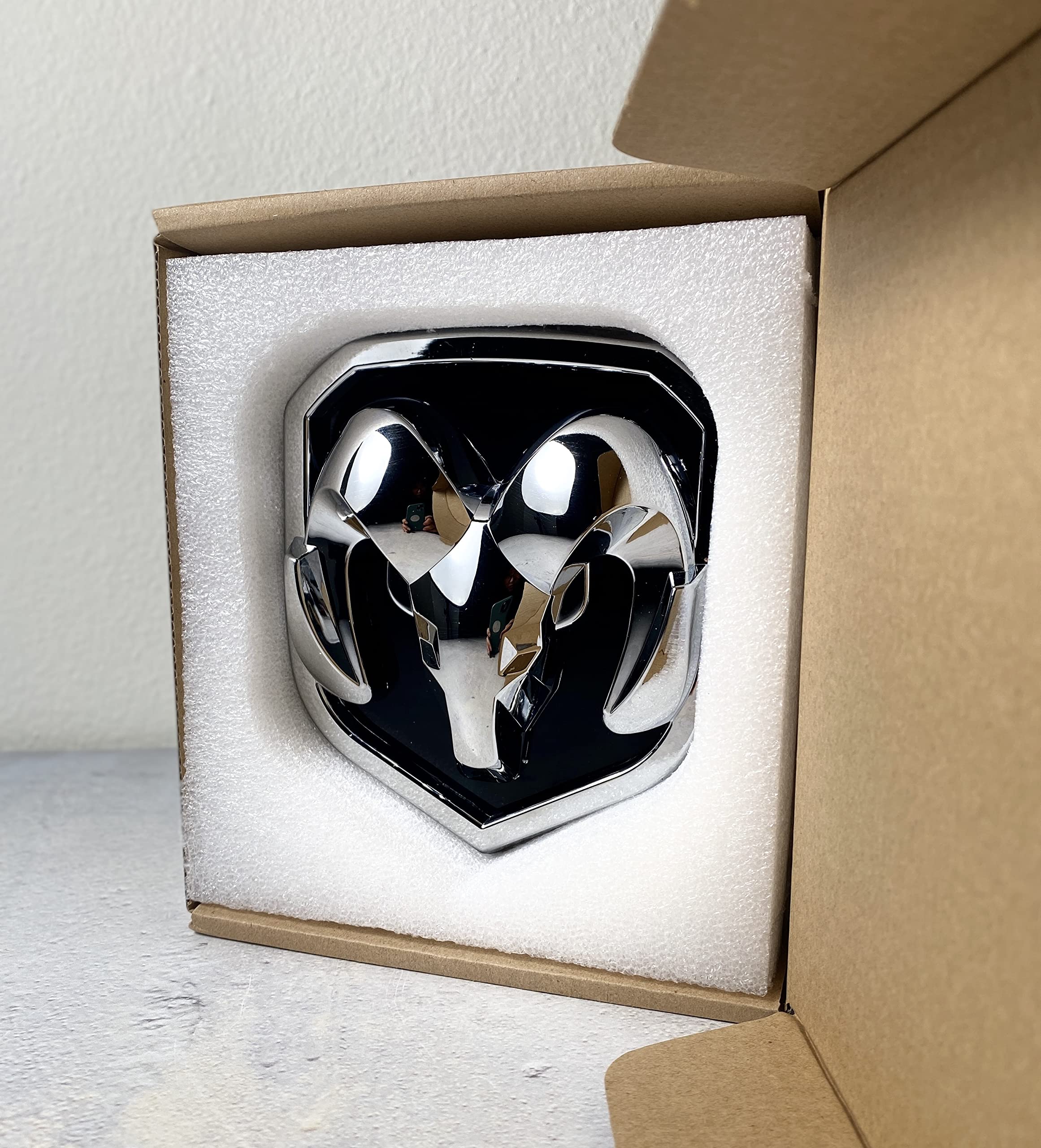 Autogem chrome emblem close-up highlighting high-gloss chrome coating.