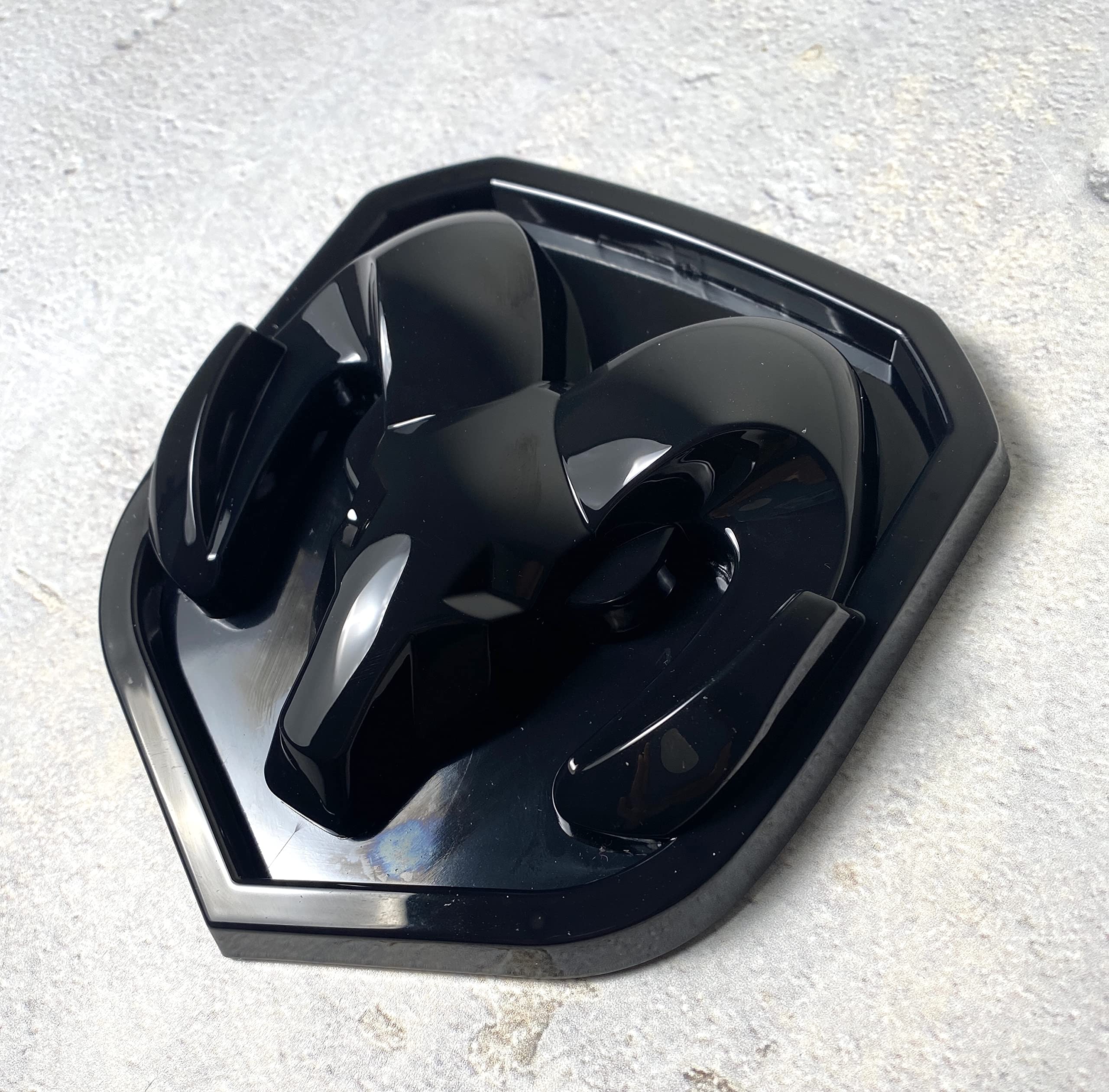 Autogem grille emblem in glossy black for RAM 1500 enhances front-end style.