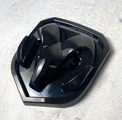 Autogem grille emblem in glossy black for RAM 1500 enhances front-end style.