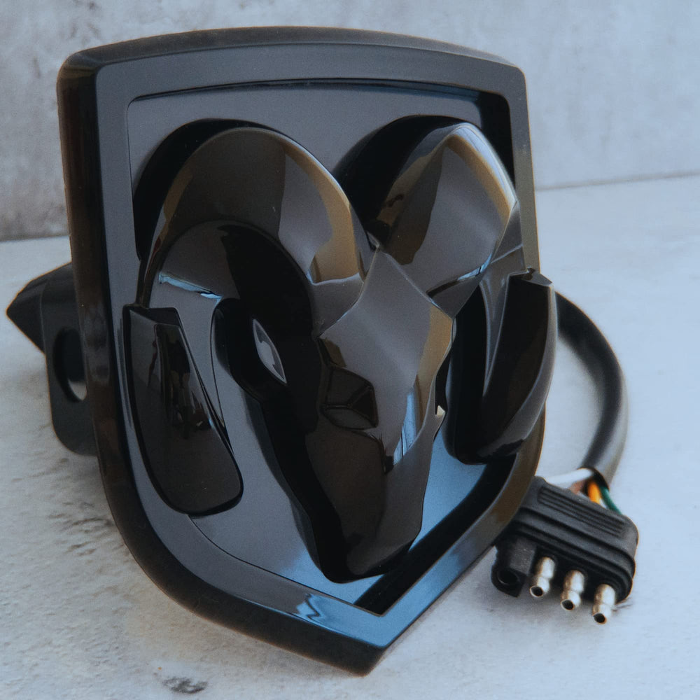 Autogem RAM Truck LED Hitch Cover face shows logo through black finish