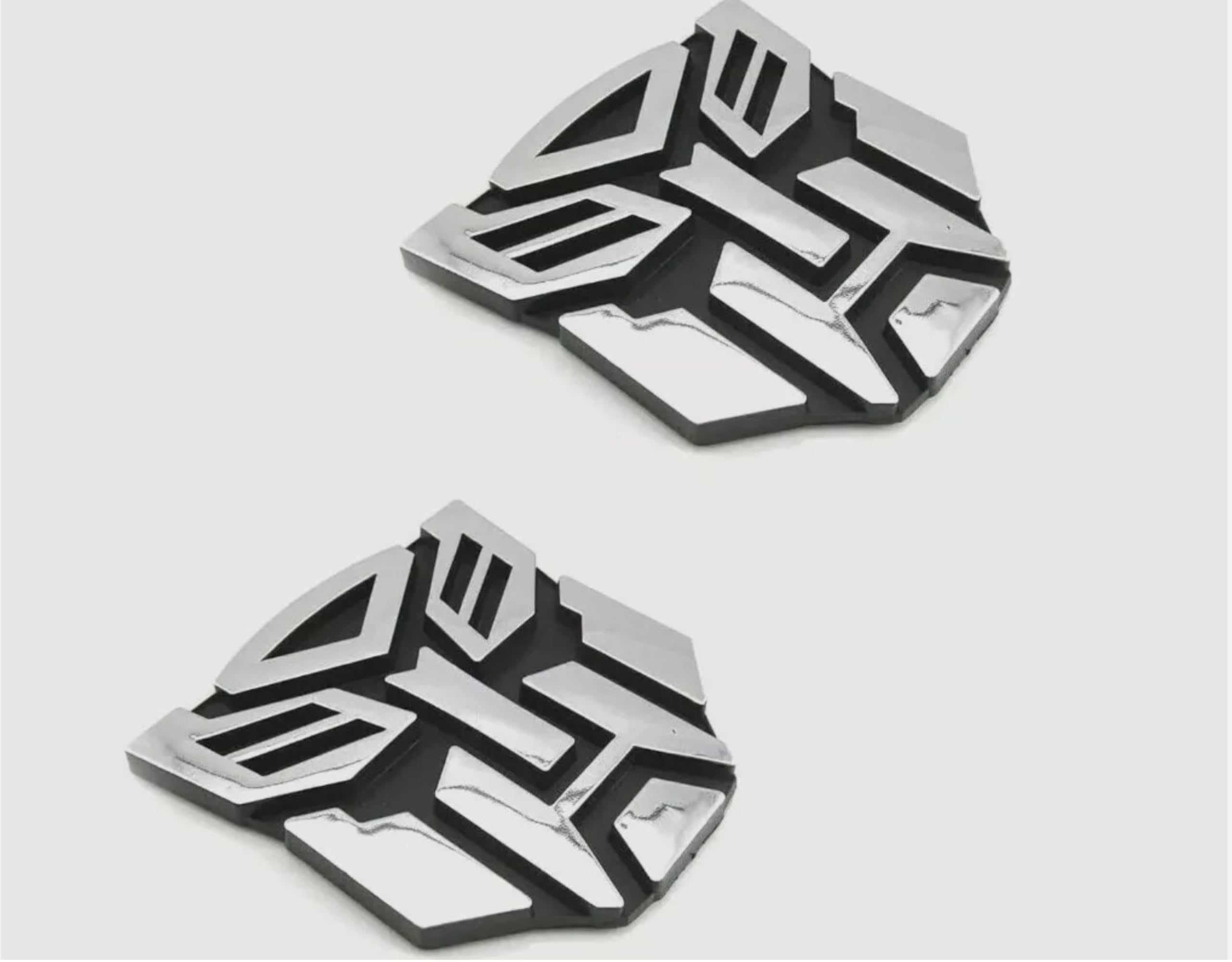 Autogem transforming robot emblem with chrome finish enhances exterior style.