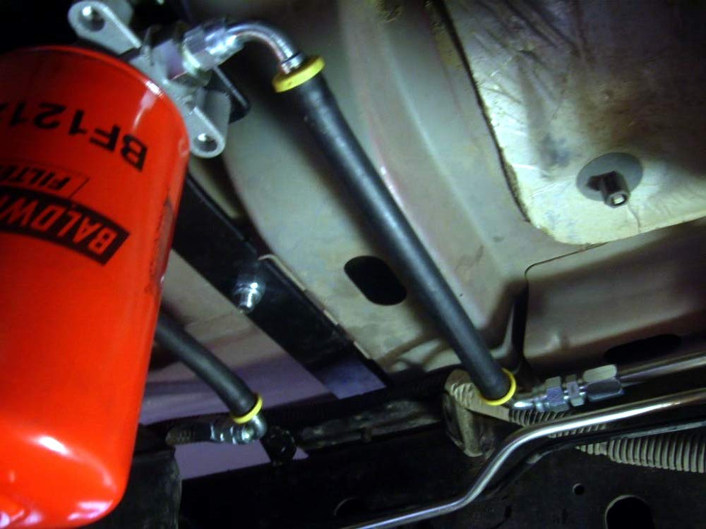 Installation-ready Baldwin BF1212, red diesel filter for heavy-duty engines.